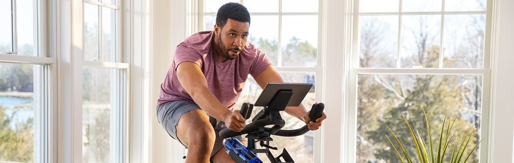 man riding a c6 indoor cycling bike